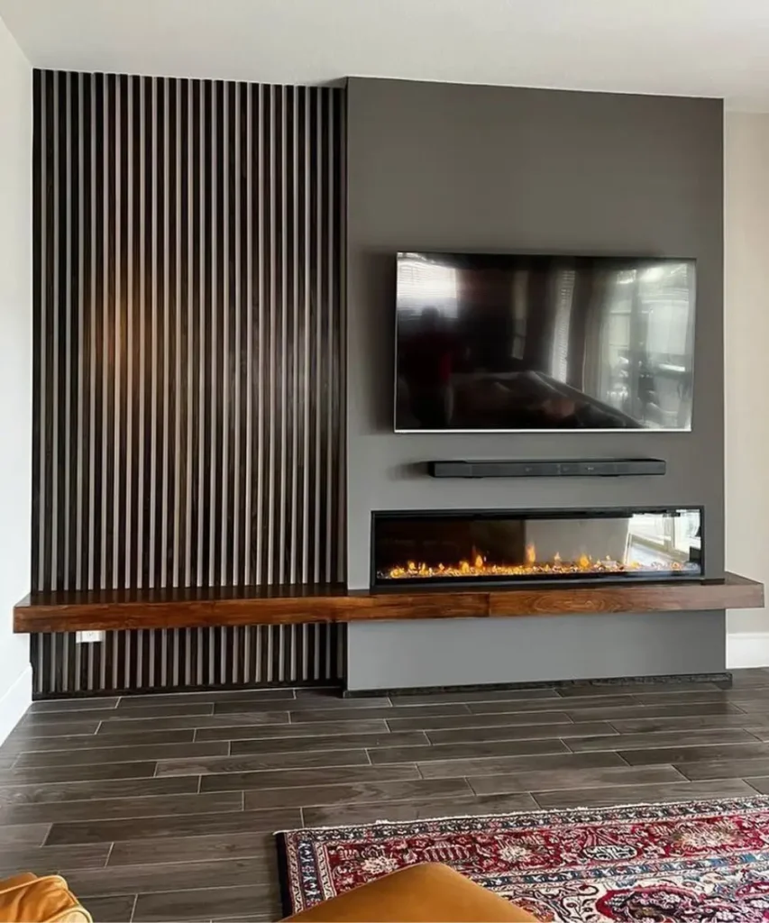 Industrial-style concrete fireplace wall with TV and neutral furnishings.