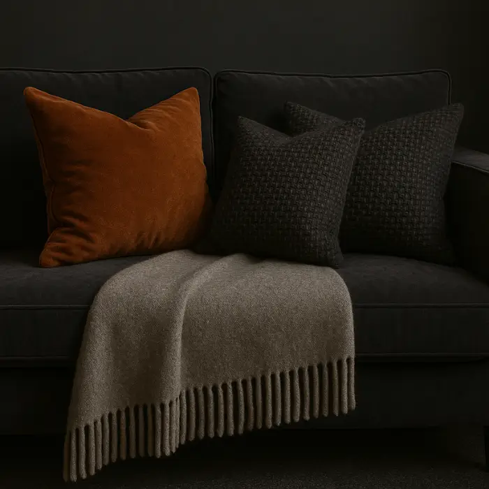 Luxurious velvet sofa in a moody living room with layered fabrics.