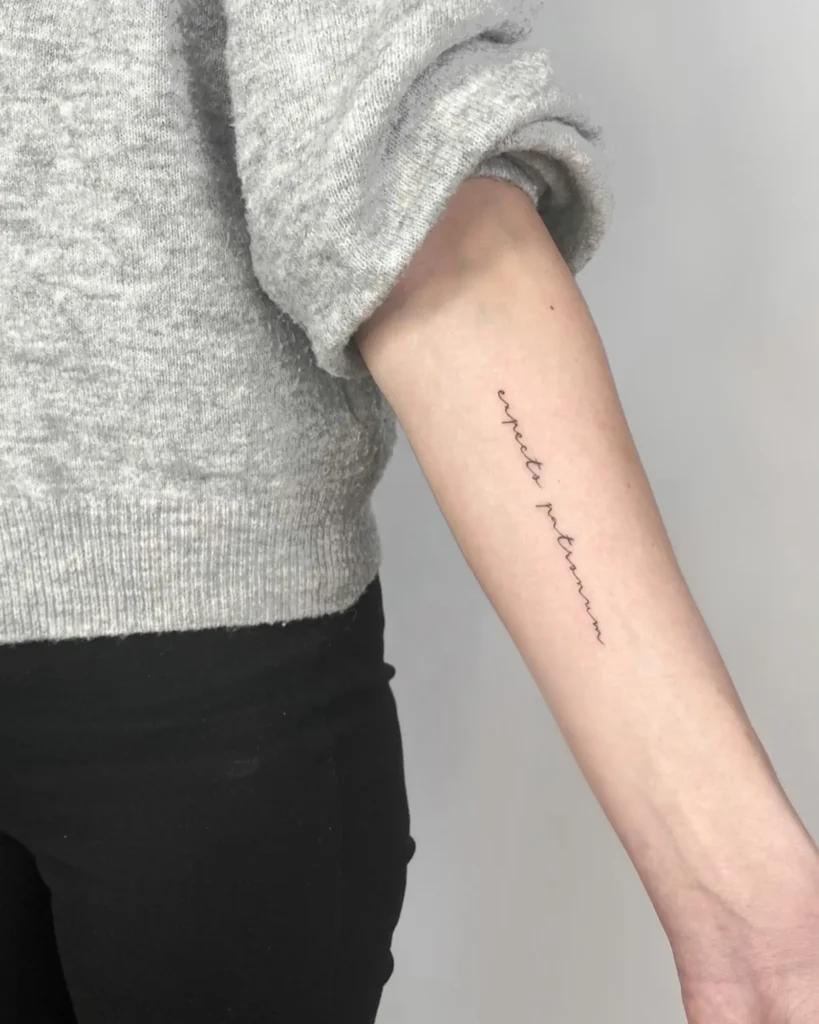 Fine Script Word Tattoo – A Personal Reminder Written on the Skin